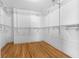 Spacious walk-in closet featuring wood flooring and ample wire shelving at 5615 Se 113Th Pl, Belleview, FL 34420