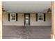 Charming front porch with ceiling fans, offering a cozy spot for relaxing outdoors at 5615 Se 113Th Pl, Belleview, FL 34420