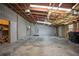 The unfinished garage includes concrete floor, ceiling insulation, and a side entry door at 5615 Se 113Th Pl, Belleview, FL 34420