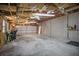 A spacious garage featuring unfinished ceiling, two garage doors, and lots of potential at 5615 Se 113Th Pl, Belleview, FL 34420