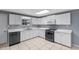 The kitchen has white cabinets, tile floors, and stainless steel appliances at 5615 Se 113Th Pl, Belleview, FL 34420