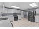 Bright kitchen with white cabinets, stainless appliances, and tile floors at 5615 Se 113Th Pl, Belleview, FL 34420