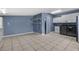 This large laundry room features tile floors, built-in shelving, and washer/dryer at 5615 Se 113Th Pl, Belleview, FL 34420