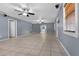 Spacious living room with gray walls, tile floors, and abundant natural light at 5615 Se 113Th Pl, Belleview, FL 34420