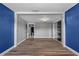 Open-concept living room with plank floors and neutral walls at 5615 Se 113Th Pl, Belleview, FL 34420