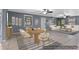 Open-concept living room and dining area with large windows and neutral tones throughout at 5615 Se 113Th Pl, Belleview, FL 34420