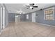Bright living room with tile floors, ceiling fans, and an open floor plan at 5615 Se 113Th Pl, Belleview, FL 34420
