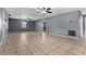 Large living room showcasing tile flooring, ceiling fans, and ample natural light at 5615 Se 113Th Pl, Belleview, FL 34420