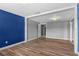 This open living room boasts plank flooring, neutral walls, and ample lighting at 5615 Se 113Th Pl, Belleview, FL 34420