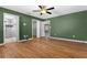 Hardwood floored main bedroom with multiple entryways to bathroom and closets at 5615 Se 113Th Pl, Belleview, FL 34420