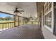 Relaxing screened porch featuring wood flooring, ceiling fans, and an exterior view at 5615 Se 113Th Pl, Belleview, FL 34420