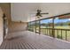 Spacious screened porch with wooden flooring and view of the outdoors at 5615 Se 113Th Pl, Belleview, FL 34420