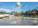 Cherokee Park splash pad with water tower backdrop offers a playful water feature for community enjoyment at 5615 Se 113Th Pl, Belleview, FL 34420
