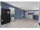This utility room has tile flooring, built in storage, appliances, and a window allowing natural light at 5615 Se 113Th Pl, Belleview, FL 34420