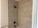 Bathroom showcasing tiled shower and updated fixtures at 74 Fisher Terrace, Ocklawaha, FL 32179