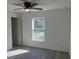 Bright and airy bedroom featuring neutral walls, wood-look floors, and a ceiling fan at 74 Fisher Terrace, Ocklawaha, FL 32179
