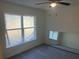 Bright and airy bedroom featuring neutral walls, wood-look floors, and a ceiling fan and a full-length mirror at 74 Fisher Terrace, Ocklawaha, FL 32179