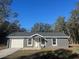 Charming single-story home featuring a one-car garage and a well-manicured front lawn at 74 Fisher Terrace, Ocklawaha, FL 32179