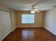 Bright bedroom featuring hardwood floors, a ceiling fan, and natural light from a window at 7407 Sw 112Th Pl, Ocala, FL 34476