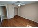 Bedroom features hardwood floors, neutral paint, ceiling fan, and closet at 7407 Sw 112Th Pl, Ocala, FL 34476