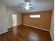 Bedroom featuring hardwood floors, a ceiling fan, and a connecting bathroom at 7407 Sw 112Th Pl, Ocala, FL 34476