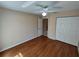Bedroom with ceiling fan, hardwood floors, neutral paint, and walk in closet at 7407 Sw 112Th Pl, Ocala, FL 34476
