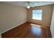 Bedroom with ceiling fan, hardwood floors, neutral paint, and ample natural light at 7407 Sw 112Th Pl, Ocala, FL 34476