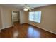 Bedroom with ceiling fan, hardwood floors, neutral paint, and walk in closet at 7407 Sw 112Th Pl, Ocala, FL 34476
