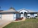 Charming single-story home featuring a well-manicured lawn, two-car garage, and a welcoming front entrance at 7407 Sw 112Th Pl, Ocala, FL 34476