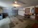 Large two car garage featuring workbench, storage racks, and an automatic garage door opener at 7407 Sw 112Th Pl, Ocala, FL 34476