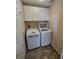 Laundry room with a modern, front-loading washer and dryer and overhead cabinets for storage at 7407 Sw 112Th Pl, Ocala, FL 34476