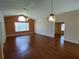 Bright living room featuring hardwood floors, ceiling fan, and open layout for entertaining and relaxation at 7407 Sw 112Th Pl, Ocala, FL 34476