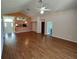Open-concept living room with hardwood floors, vaulted ceilings, and a view to the kitchen at 7407 Sw 112Th Pl, Ocala, FL 34476