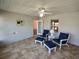 Comfortable sunroom featuring tiled floor and a sitting area to enjoy the view at 7407 Sw 112Th Pl, Ocala, FL 34476
