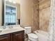 Bathroom featuring a vanity, toilet, and shower-tub combo at 7527 Sw 97Th Terrace Rd, Ocala, FL 34481