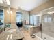 Bright bathroom featuring double sinks, separate shower, and soaking tub with shuttered windows at 7527 Sw 97Th Terrace Rd, Ocala, FL 34481