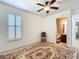 Bright bedroom with a patterned rug, and ensuite bathroom at 7527 Sw 97Th Terrace Rd, Ocala, FL 34481
