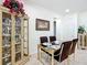 Dining room with a glass table, seating for four, and display cabinet at 7527 Sw 97Th Terrace Rd, Ocala, FL 34481