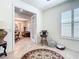 Bright entryway featuring French doors, tile flooring, and a view into the adjacent living room at 7527 Sw 97Th Terrace Rd, Ocala, FL 34481