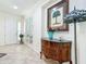 Elegant foyer with tile flooring, decorative console table, and bright lighting at 7527 Sw 97Th Terrace Rd, Ocala, FL 34481