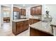 Open kitchen layout with stainless steel appliances, large island, and granite countertops at 7527 Sw 97Th Terrace Rd, Ocala, FL 34481