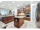 Large kitchen featuring an island, stainless steel appliances, and dark wood cabinetry at 7527 Sw 97Th Terrace Rd, Ocala, FL 34481