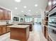 Spacious kitchen featuring granite countertops, stainless steel appliances and an island with barstool seating at 7527 Sw 97Th Terrace Rd, Ocala, FL 34481