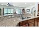 Close up of granite countertops with a stainless steel sink and breakfast bar in the kitchen at 7527 Sw 97Th Terrace Rd, Ocala, FL 34481