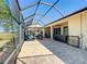 Covered lanai featuring a patio, hot tub, and views of the surrounding landscape at 7527 Sw 97Th Terrace Rd, Ocala, FL 34481