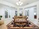 Spacious living room with elegant furnishings and beautiful lighting fixtures at 7527 Sw 97Th Terrace Rd, Ocala, FL 34481