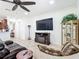 Comfortable living room with a fireplace, large TV, and plenty of seating at 7527 Sw 97Th Terrace Rd, Ocala, FL 34481
