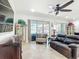 Cozy living room with a ceiling fan, sliding glass doors to the patio and comfortable seating at 7527 Sw 97Th Terrace Rd, Ocala, FL 34481