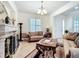 Inviting living room featuring a fireplace, tile floors, and elegant furnishings at 7527 Sw 97Th Terrace Rd, Ocala, FL 34481