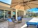Outdoor patio with seating, a hot tub, and an umbrella at 7527 Sw 97Th Terrace Rd, Ocala, FL 34481
